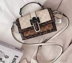 Coach 
Studded Flap Sling Bag